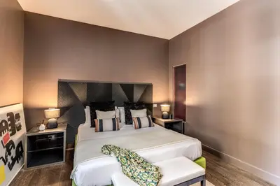 a bedroom with a large bed and two chairs at Telier Tomacelli in Rome