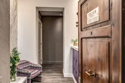 a hallway with a wooden door and a chair at Telier Tomacelli in Rome