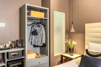a bedroom with a closet with a bed and a mirror at Telier Tomacelli in Rome