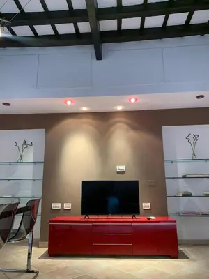 a living room with a flat screen tv and a table at Mc - Trastevere in Rome