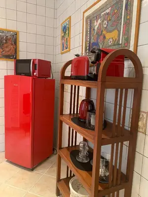 a kitchen with a red refrigerator and shelves with appliances at Mc - Trastevere in Rome