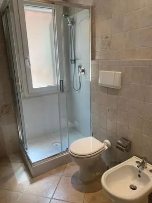 a bathroom with a shower and a toilet and a sink at Mc - Trastevere in Rome
