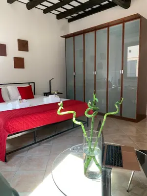 a bedroom with a bed and a vase with a plant at Mc - Trastevere in Rome