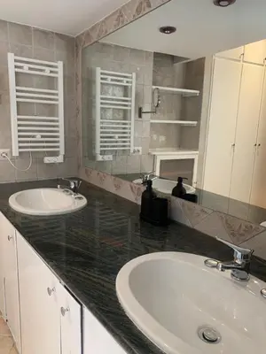 a bathroom with two sinks and a large mirror at Mc - Trastevere in Rome