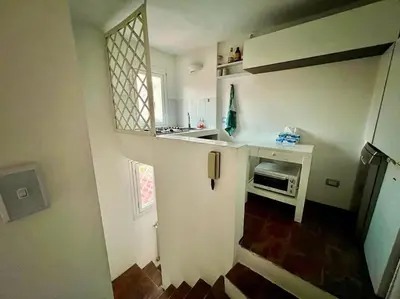 a small kitchen with a sink and a refrigerator at La Rosa di piazza Spagna in Rome