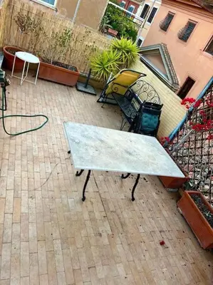 a table and chairs on a patio on a balcony at La Rosa di piazza Spagna in Rome