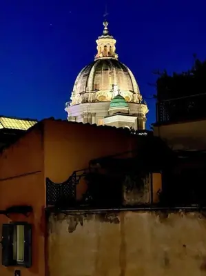 a dome of a building with a building with a building at La Rosa di piazza Spagna in Rome
