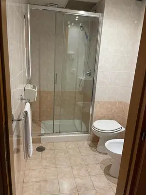 a bathroom with a shower and a toilet at Mille Guest HOUSE in Rome