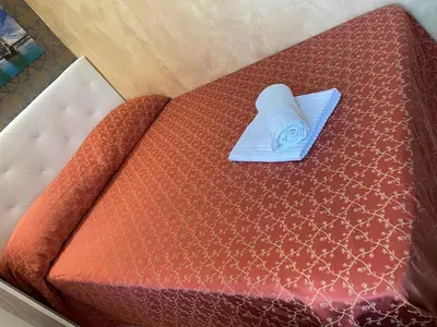 a bed with a blue pillow on top of it at Mille Guest HOUSE in Rome