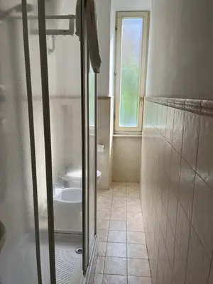 a bathroom with a shower and a tub and a sink at House of Mia in Prati in Rome