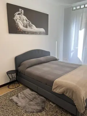 a bedroom with a bed with a statue on the wall at House of Mia in Prati in Rome