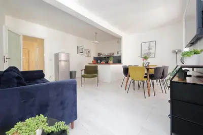 a living room with a blue couch and a table at Monti Spacious Apartment 2 in Rome