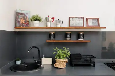 a kitchen counter with a sink and some shelves at Monti Spacious Apartment 2 in Rome
