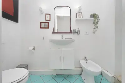 a white bathroom with a sink and a toilet at Monti Spacious Apartment 2 in Rome