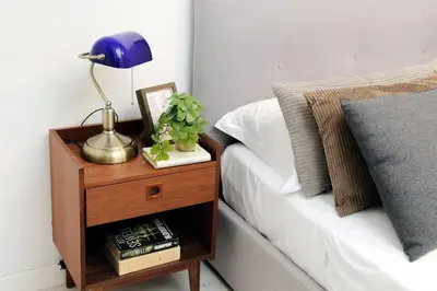 a blue lamp on a night stand next to a bed at Monti Spacious Apartment 2 in Rome
