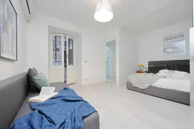 a living room with a bed and a couch at Monti Spacious Apartment 2 in Rome