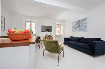 a living room with a blue couch and a bowl of fruit at Monti Spacious Apartment 2 in Rome