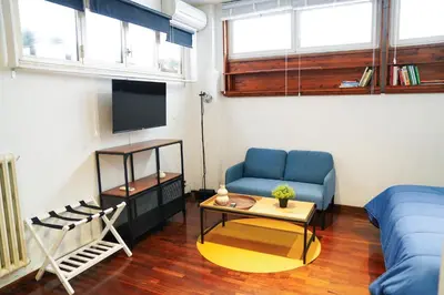 a living room with a blue couch and a table at babuino terrace in Rome