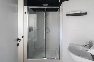 a glass shower in a bathroom with a sink at Loft 36 by Nosdom Properties in Rome