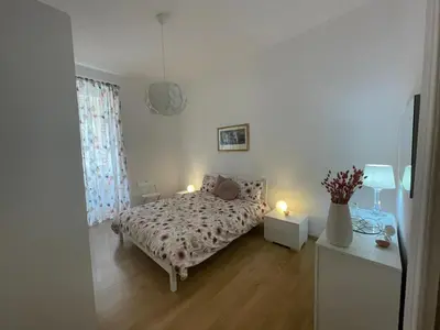 a bedroom with a bed and two lamps and a window at Domus Roma Esquilino in Rome