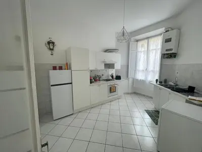 a kitchen with white appliances and a tile floor at Domus Roma Esquilino in Rome