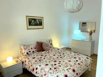 a bedroom with a bed and two night stands at Domus Roma Esquilino in Rome