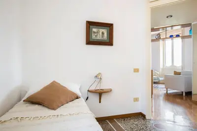 a bedroom with a bed with a picture on the wall at Refined upper-level apartment - Unique View of Rome's Skyline Tibernestrome in Rome