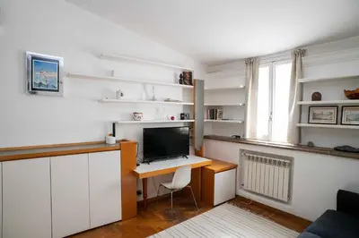 a room with a desk with a computer and a window at Tamara e Gerardina House in Trastevere in Rome
