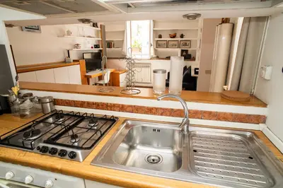 a kitchen with a sink and a stove at Tamara e Gerardina House in Trastevere in Rome