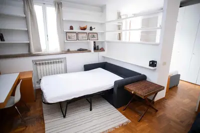 a small room with a bed and a table at Tamara e Gerardina House in Trastevere in Rome
