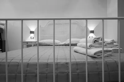 a small bedroom with two beds and a mirror at Guest house San Lorenz in Rome
