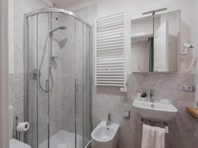 a bathroom with a shower and a sink at The Best Rent - Modern three-bedroom apartment a few steps from the Colosseum in Rome