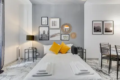 a bedroom with a large white bed with yellow pillows at BDC - Egeria 3-Bdr huge apartment in Rome