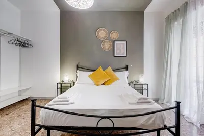 a bedroom with a large white bed with yellow pillows at BDC - Egeria 3-Bdr huge apartment in Rome