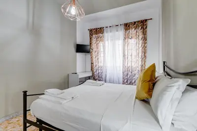 a bedroom with a white bed and a window at BDC - Egeria 3-Bdr huge apartment in Rome