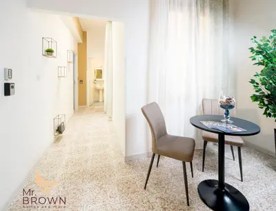 a dining room with a table and chairs and a hallway at Mr. Brown - Marconi in Rome
