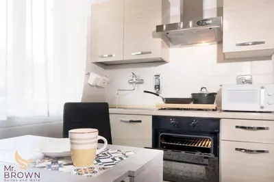 a kitchen with a table with a cup of coffee on it at Mr. Brown - Marconi in Rome