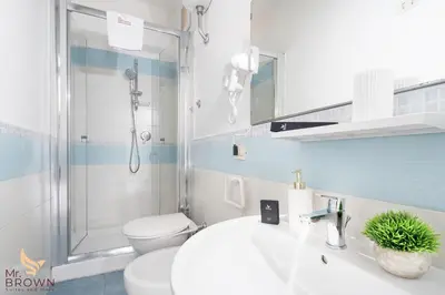 a bathroom with a shower and a sink and a toilet at Mr. Brown - Marconi in Rome