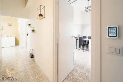 a hallway with a door leading to a dining room at Mr. Brown - Marconi in Rome