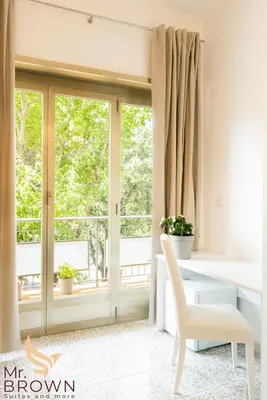a room with a window and a table and a chair at Mr. Brown - Marconi in Rome