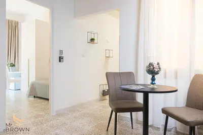 a room with a table and two chairs and a bedroom at Mr. Brown - Marconi in Rome