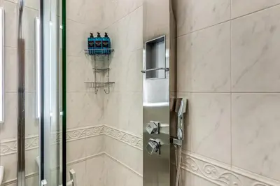 a shower with two blue bottles on the wall at Rhome Colosseum in Rome