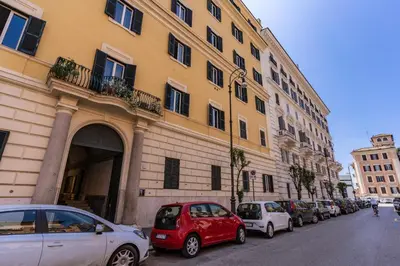 a row of cars parked in front of a building at Rhome Colosseum in Rome