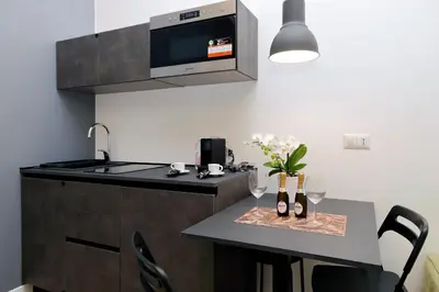 a kitchen with a table with wine glasses on it at Colosseum romantic home in Rome