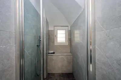 a bathroom with a shower and a window in it at Colosseum romantic home in Rome