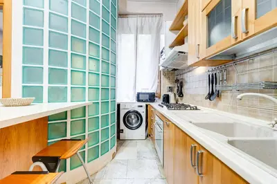 a kitchen with a sink and a washing machine at Vatican - Zen Style loft with Jacuzzi in Rome