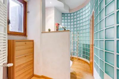 a bathroom with a shower with blue tiles at Vatican - Zen Style loft with Jacuzzi in Rome
