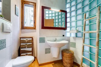 a bathroom with a sink and a toilet and a mirror at Vatican - Zen Style loft with Jacuzzi in Rome