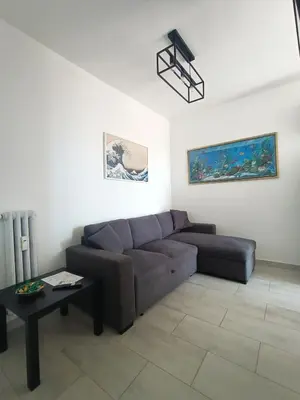 a living room with a couch and a table at La Terrazza sull'Appia by Hostand in Rome