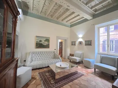 a living room with white furniture and a coffered ceiling at Trevi Luxury in Rome